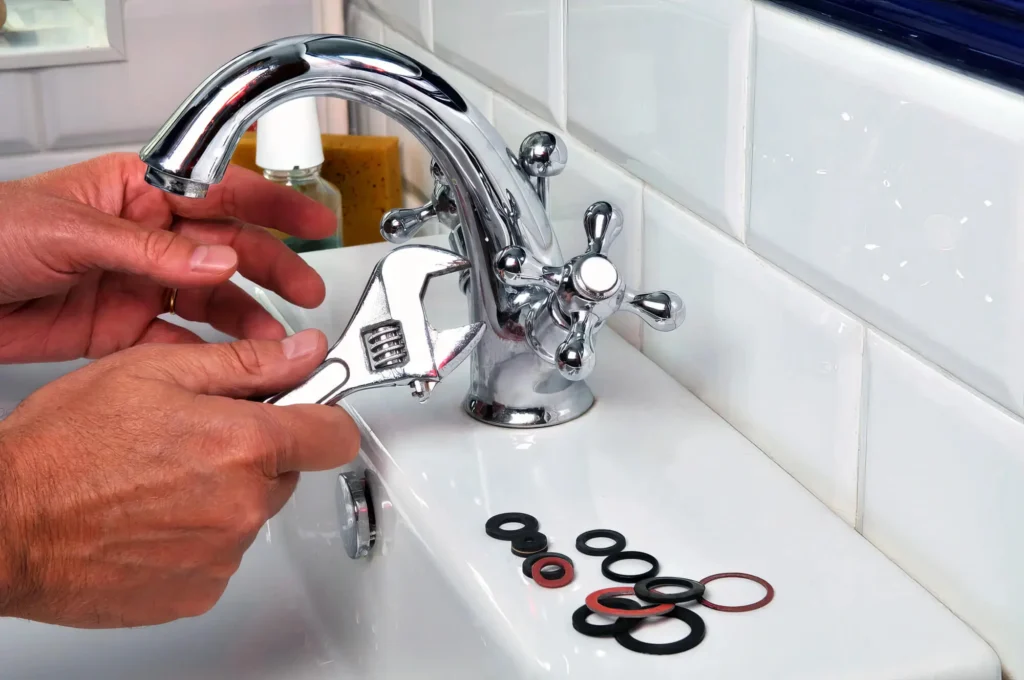 Plumber performing maintenance on a bathroom faucet in Morgan Hill