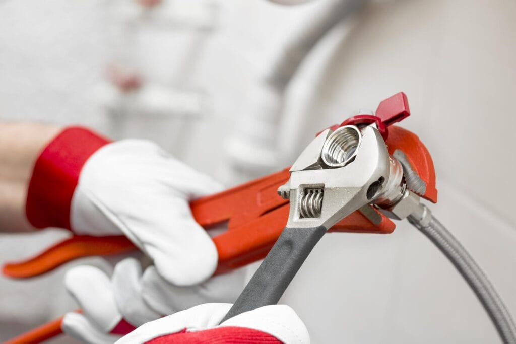 Plumber holding pipe wrenches for an emergency repair in Morgan Hill