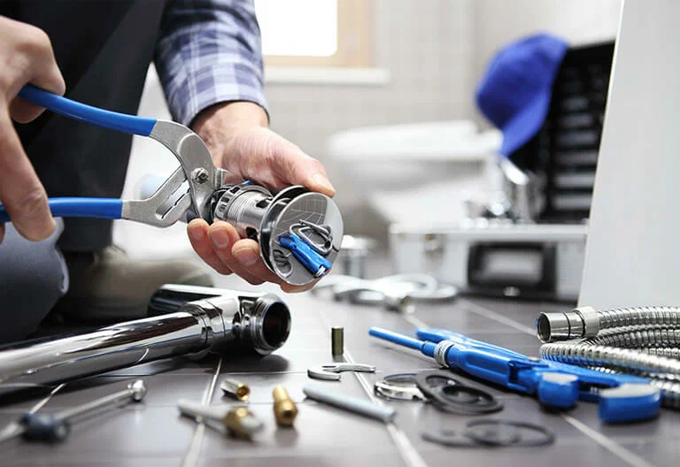 Technician repairing a plumbing fixture with professional tools in Morgan Hill