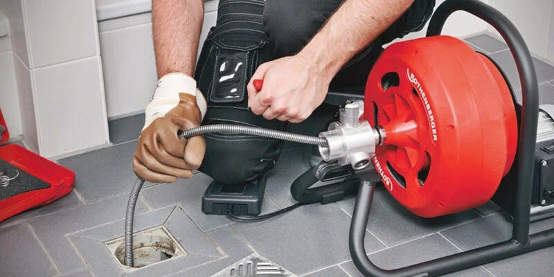 Plumber using a drain-cleaning machine in Morgan Hill