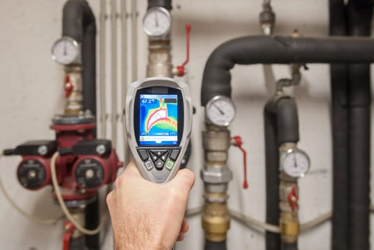 Plumber using a thermal imaging camera to inspect pipes in Morgan Hill