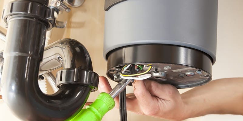 Technician repairing the heating element of a water heater in Morgan Hill