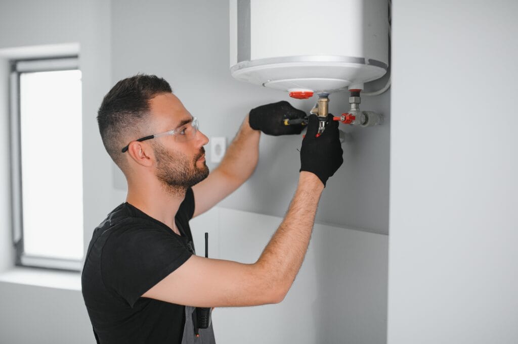 Technician performing water heater maintenance in Morgan Hill