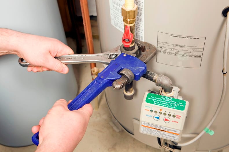 Plumber repairing a water heater valve in Morgan Hill